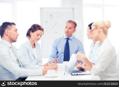 business concept - business team having meeting in office. business team having meeting in office