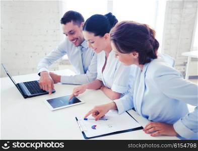 business concept - business team working with tablet pc and laptop in office. business team working in office