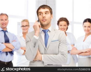 business concept - businessman talking on the phone in office