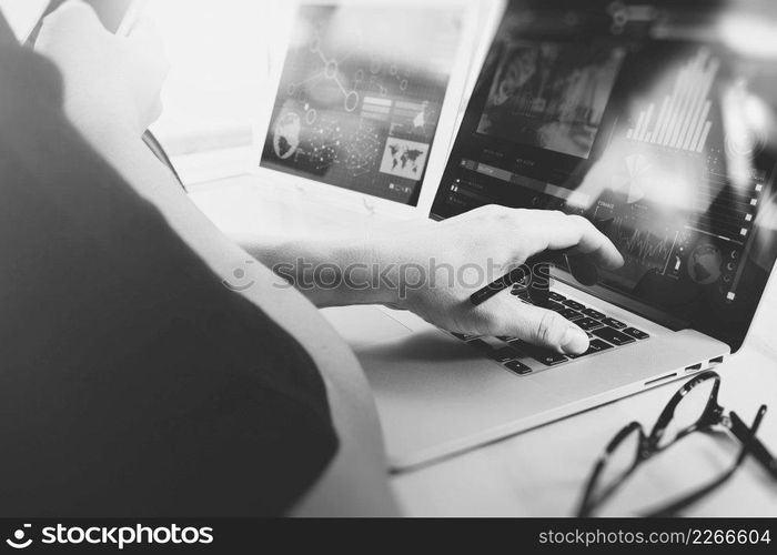 business concept.Businessman working stock exchange project modern office.Laptop computer digital table and smart phone.Internet connection technology, black white