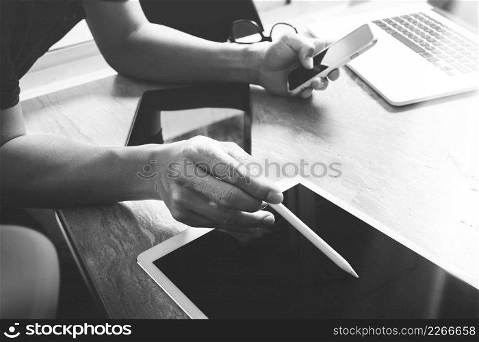 business concept.Businessman working stock exchange project modern office.Laptop computer digital table and smart phone.Internet connection technology, black white
