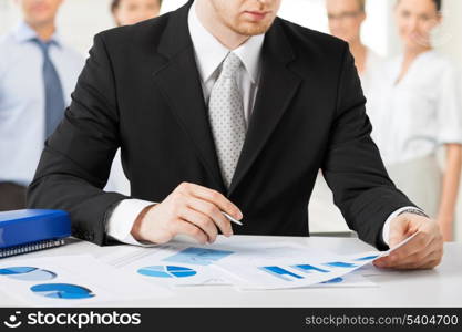 business concept - businessman working with papers