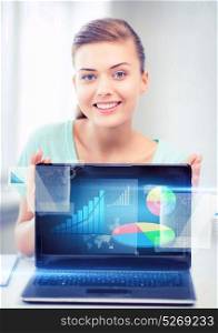 business concept - businesswoman showing laptop with graph. businesswoman showing laptop with graph