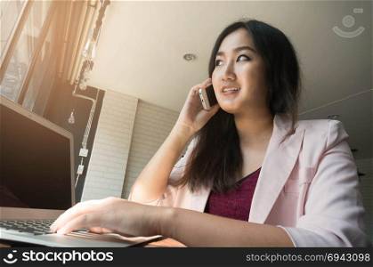 business concept - businesswoman talking on the phone in office.
