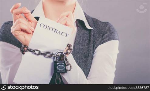 Business concept. businesswoman with chained hands holding contract