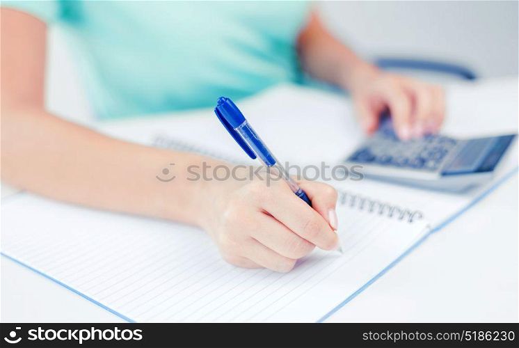 business concept - businesswoman working with calculator in office. businesswoman working with calculator in office