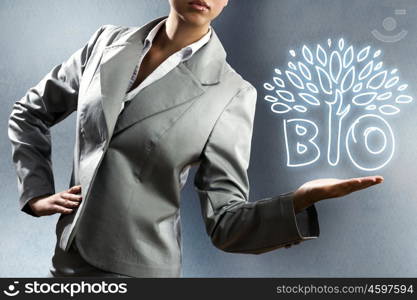 Business concept. Close up of businesswoman with sketches at background. Ecology concept