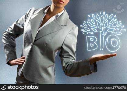 Business concept. Close up of businesswoman with sketches at background. Ecology concept