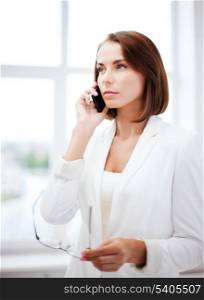 business concept - confused woman with smartphone
