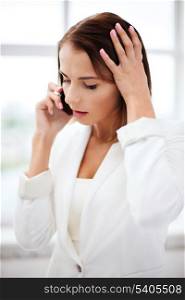 business concept - confused woman with smartphone in office