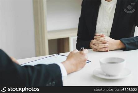Business concept - Executives at desk discussion sales performance in a office.