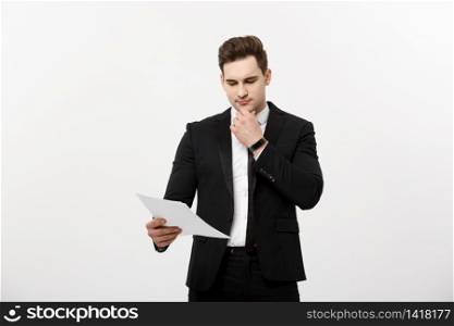 Business Concept: Focused handsome businessman thinking of annually business report ,revenue or document.. Business Concept: Focused handsome businessman thinking of annually business report ,revenue or document