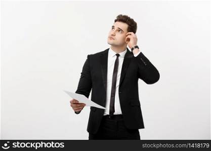 Business Concept: Focused handsome businessman thinking of annually business report ,revenue or document.. Business Concept: Focused handsome businessman thinking of annually business report ,revenue or document