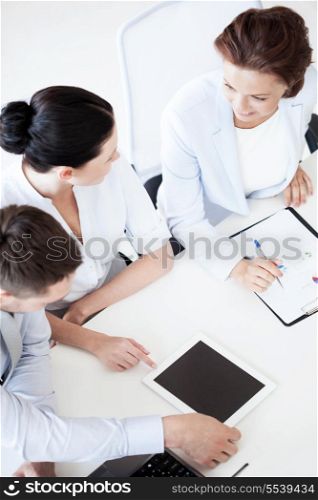business concept - friendly business team having discussion in office