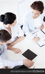 business concept - friendly business team having discussion in office