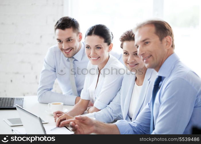 business concept - friendly business team having meeting in office