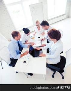 business concept - friendly business team having meeting in office. business team having meeting in office