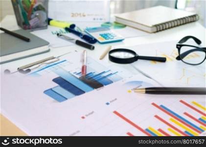 Business Concept. Graphs and Charts Report with pen on desk.
