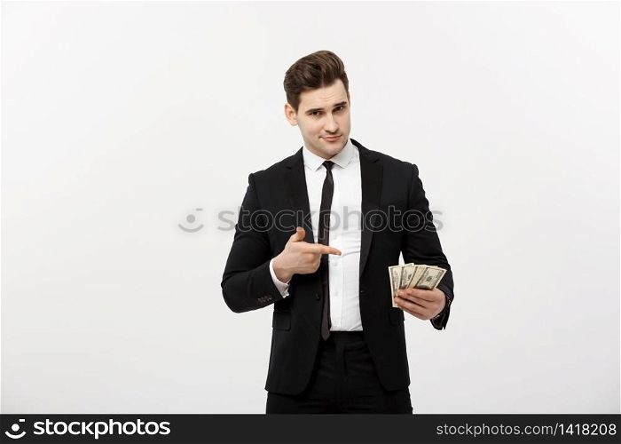 Business Concept: Handsome Businessman in suit pointing finger to money. Isolated on white background. Business Concept: Handsome Businessman in suit pointing finger to money. Isolated on white background.
