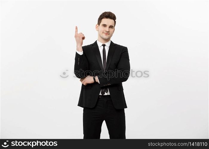 Business Concept: Handsome businessman with a finger pointed up isolated over white background.. Business Concept: Handsome businessman with a finger pointed up isolated over white background
