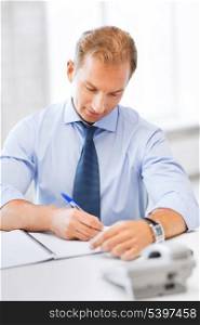 business concept - handsome businessman working in the office