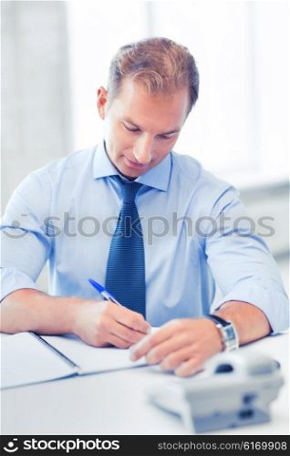 business concept - handsome businessman working in the office. handsome businessman working in the office