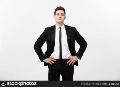 Business Concept: Handsome Man Happy Smile Young Handsome Guy in smart suit posing over Isolated Grey Background. Business Concept: Handsome Man Happy Smile Young Handsome Guy in smart suit posing over Isolated Grey Background.