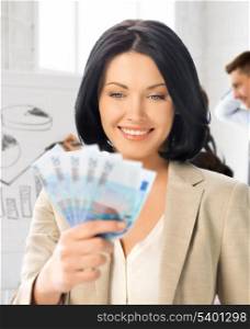 business concept - happy businesswoman with cash money in office