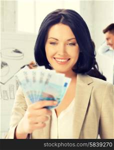 business concept - happy businesswoman with cash money in office. happy businesswoman with cash money in office