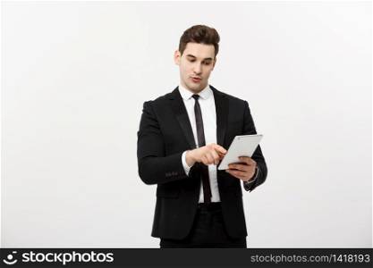 Business Concept: Happy smiling businessman pointing on digital tablet on white background.. Business Concept: Happy smiling businessman pointing on digital tablet on white background