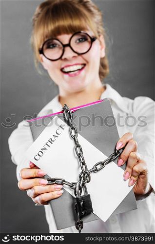 Business concept. Happy woman businesswoman holding in hands paper document contract chained with padlock