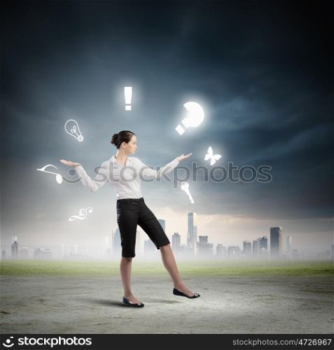 Business concept. Image of businesswoman juggling with sign and symbols