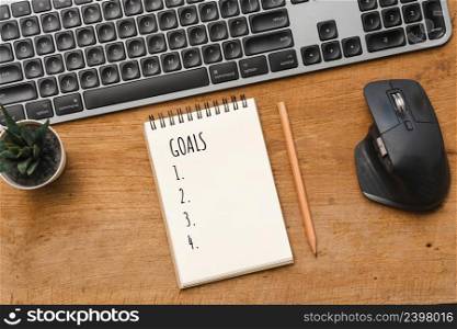 Business concept New year Goals, keyboard on wood table with note