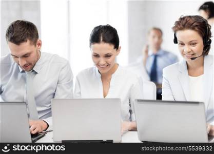 business concept - picture of group of people working with laptops in office