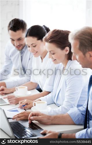 business concept - picture of group of people working with laptops in office