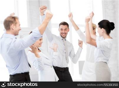 business concept - picture of happy business team celebrating victory in office