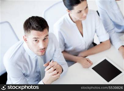 business concept - picture of serious businessman on meeting in office