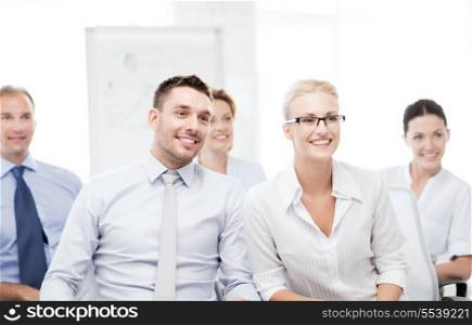 business concept - picture of smiling businessmen and businesswomen on conference