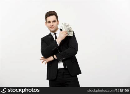 Business Concept: Portrait handsome businessman suit holding fan of dollar cash isolated over white gray background. Business Concept: Portrait handsome businessman suit holding fan of dollar cash isolated over white gray background.