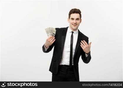 Business Concept: Portrait handsome businessman suit holding fan of dollar cash isolated over white gray background. Business Concept: Portrait handsome businessman suit holding fan of dollar cash isolated over white gray background.