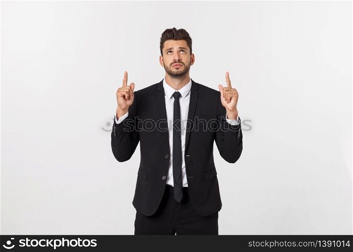Business Concept: Portrait handsome young businessman point finger on side to empty copy space. Isolated over white background.. Business Concept: Portrait handsome young businessman point finger on side to empty copy space. Isolated over white background