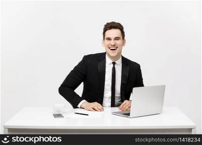 Business Concept: Portrait happy attractive businessman working on laptop at office.. Business Concept: Portrait happy attractive businessman working on laptop at office