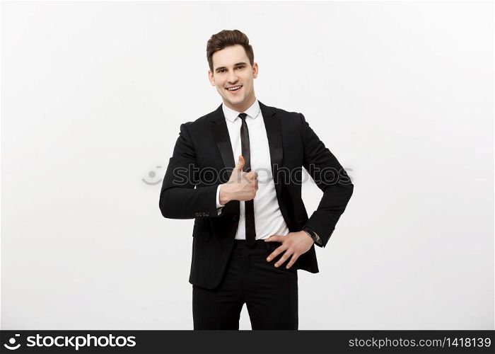 Business Concept: Portrait of excited man with opened mouth dressed in formal wear giving thumbs-up against gray background. Business Concept: Portrait of excited man with opened mouth dressed in formal wear giving thumbs-up against gray background.