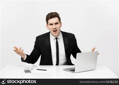 Business Concept: Portrait of screaming angry businessman sitting in office isolated over white background. Business Concept: Portrait of screaming angry businessman sitting in office isolated over white background.