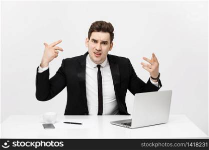Business Concept: Portrait of screaming angry businessman sitting in office isolated over white background. Business Concept: Portrait of screaming angry businessman sitting in office isolated over white background.