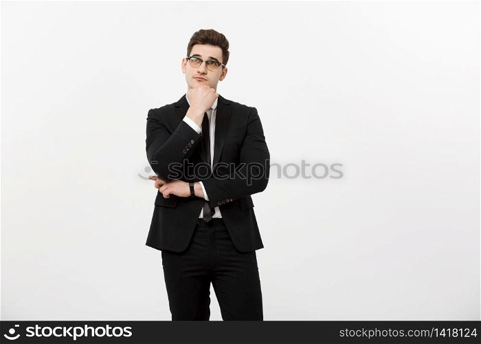 Business Concept: Portrait of Thoughtful handsome Businessman wearing smart suit in thinking gesture isolated over white background. Business Concept: Portrait of Thoughtful handsome Businessman wearing smart suit in thinking gesture isolated over white background.