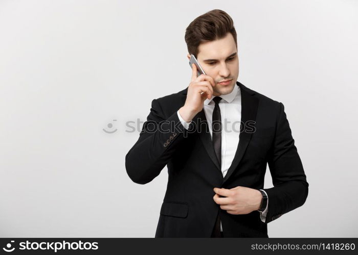 Business Concept: Portrait of young handsome businessman talking on mobile phone with serious and stress expression. Isolated over white background. Business Concept: Portrait of young handsome businessman talking on mobile phone with serious and stress expression. Isolated over white background.