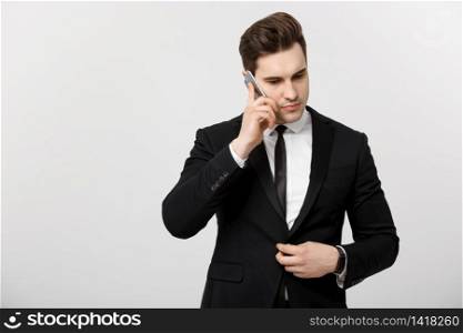 Business Concept: Portrait of young handsome businessman talking on mobile phone with serious and stress expression. Isolated over white background. Business Concept: Portrait of young handsome businessman talking on mobile phone with serious and stress expression. Isolated over white background.