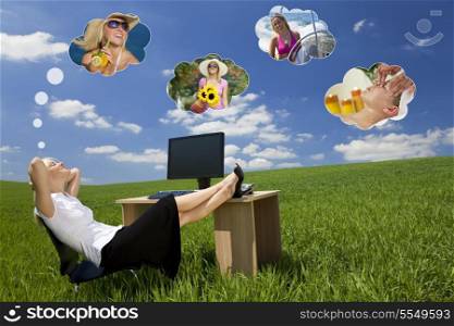 Business concept shot of a beautiful young woman relaxing at a desk in a green field day dreaming, of being on holiday. Dream clouds fill the blue sky.