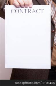 Business concept signing contract. Businessman holding blank empty paper sheet with sign contract and space for text.